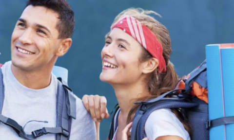 Man and woman with backpacking gear looking into the distance