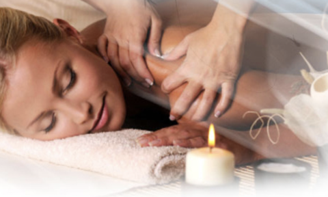 Woman laying on front with a candle 