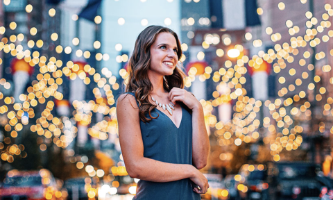 Women touching her necklace in a cityscape