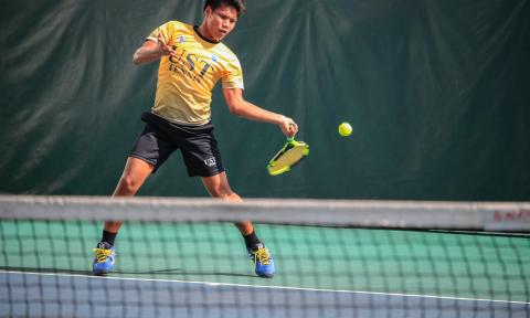 Boy playing tennis