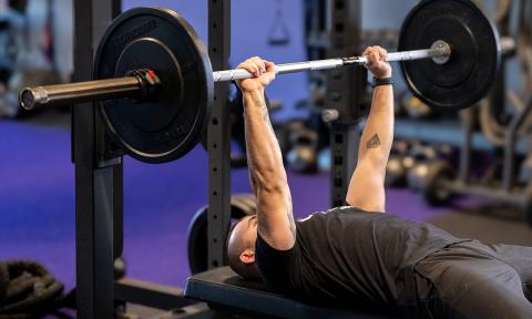 man bench pressing weights