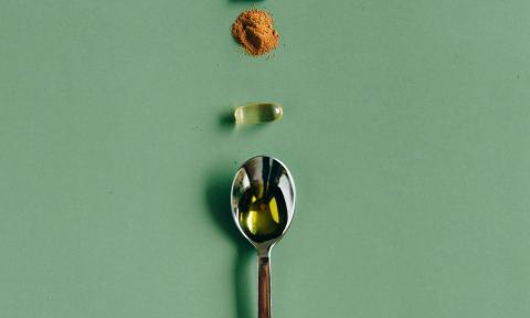 supplements and a spoon on a table