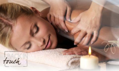 Woman laying on front with a candle, Back in Touch Massage Logo on bottom left corner