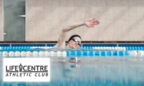 Man with swim cap and goggles swimming in a pool, Life Centre Athletic Club logo bottom left corner