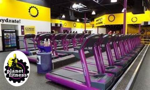 treadmills in a yellow and purple gym, Planet Fitness Logo in bottom left corner
