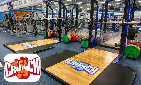 weight lifting rack and weights, Crunch fitness logo in bottom left corner
