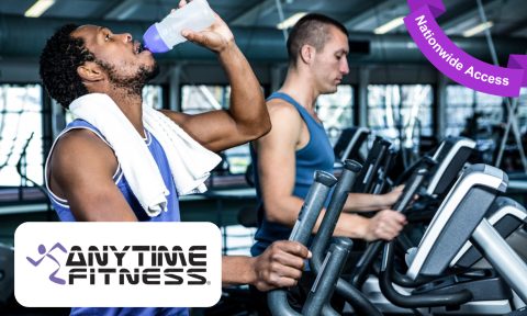 man with beard and dark hair drinking from a water bottle, on a treadmill, Anytime Fitness Logo on the bottom left corner, purple banner reading nationwide access in top right corner