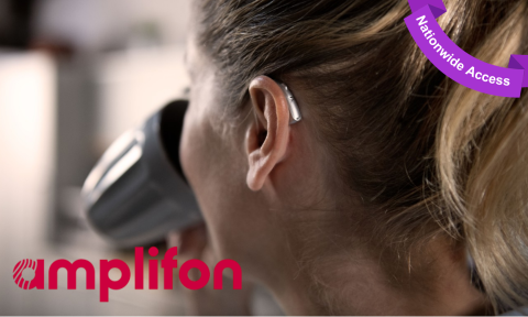 back of a woman's head, she is drinking out of a coffee cup and has a hearing aid on, purple banner top right corner reading nationwide access
