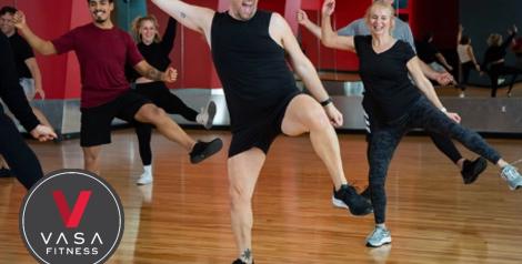 group fitness class with enthusiastic male instructor with Vasa fitness logo on bottom left corner