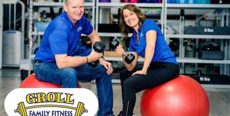 Two people sitting on rubber balls with weights, Groll Family Fitness logo in bottom left corner