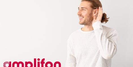 man in white shirt cupping his ear that has a hearing aid with amplifon logo in bottom left corner