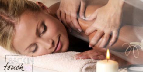 Woman laying on front with a candle, Back in Touch Massage Logo on bottom left corner
