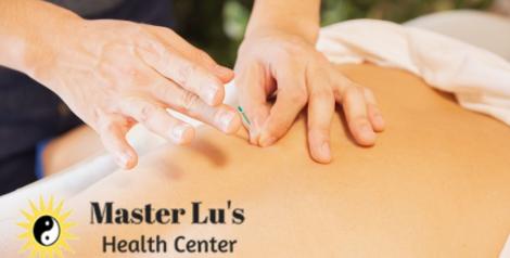 Hands placing acupuncture needle on a back with Master Lu's Health Center logo on bottom left