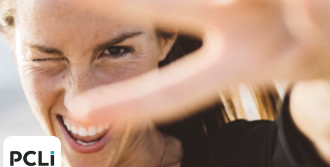 woman giving a peace sign near her eye with PCLi logo on bottom left corner