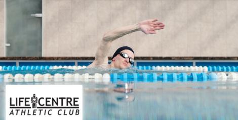 Man with swim cap and goggles swimming in a pool, Life Centre Athletic Club logo bottom left corner