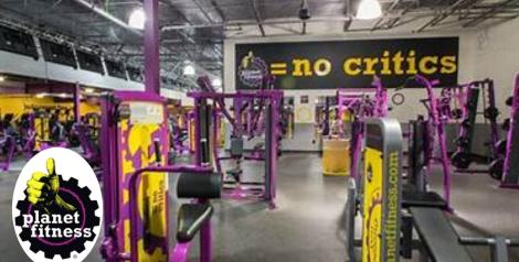 Purple, yellow, and black gym with machines and weights, Planet Fitness logo in bottom left corner