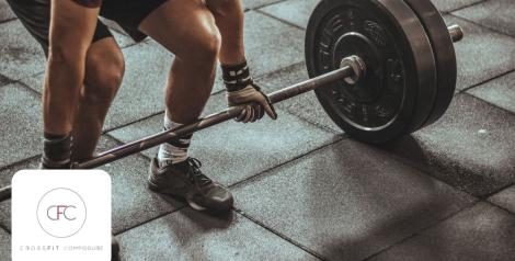 man in black shorts lifting heavy dumbbell, Crossfit Composure logo in bottom left corner