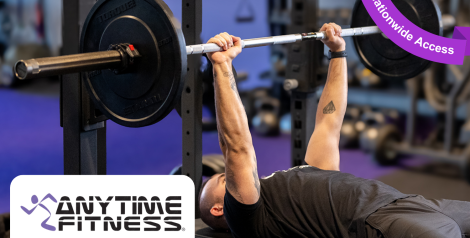 man bench pressing weights with anytime fitness logo in bottom left corner, purple banner reading nationwide access in top right corner