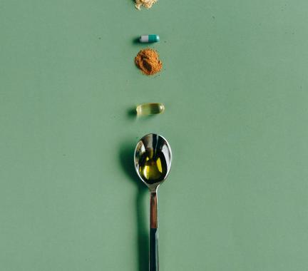 supplements and a spoon on a table